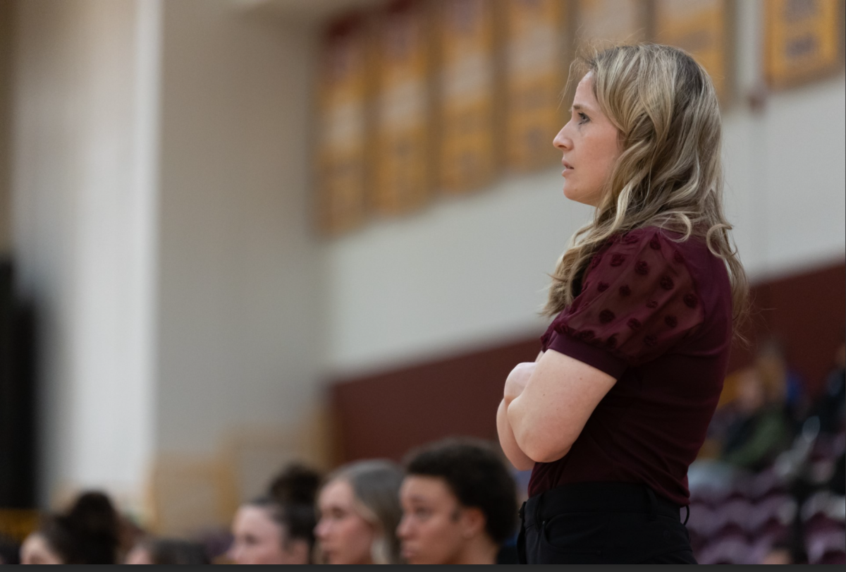 Randi Richardson-Thornley watches her team perform from the sidelines